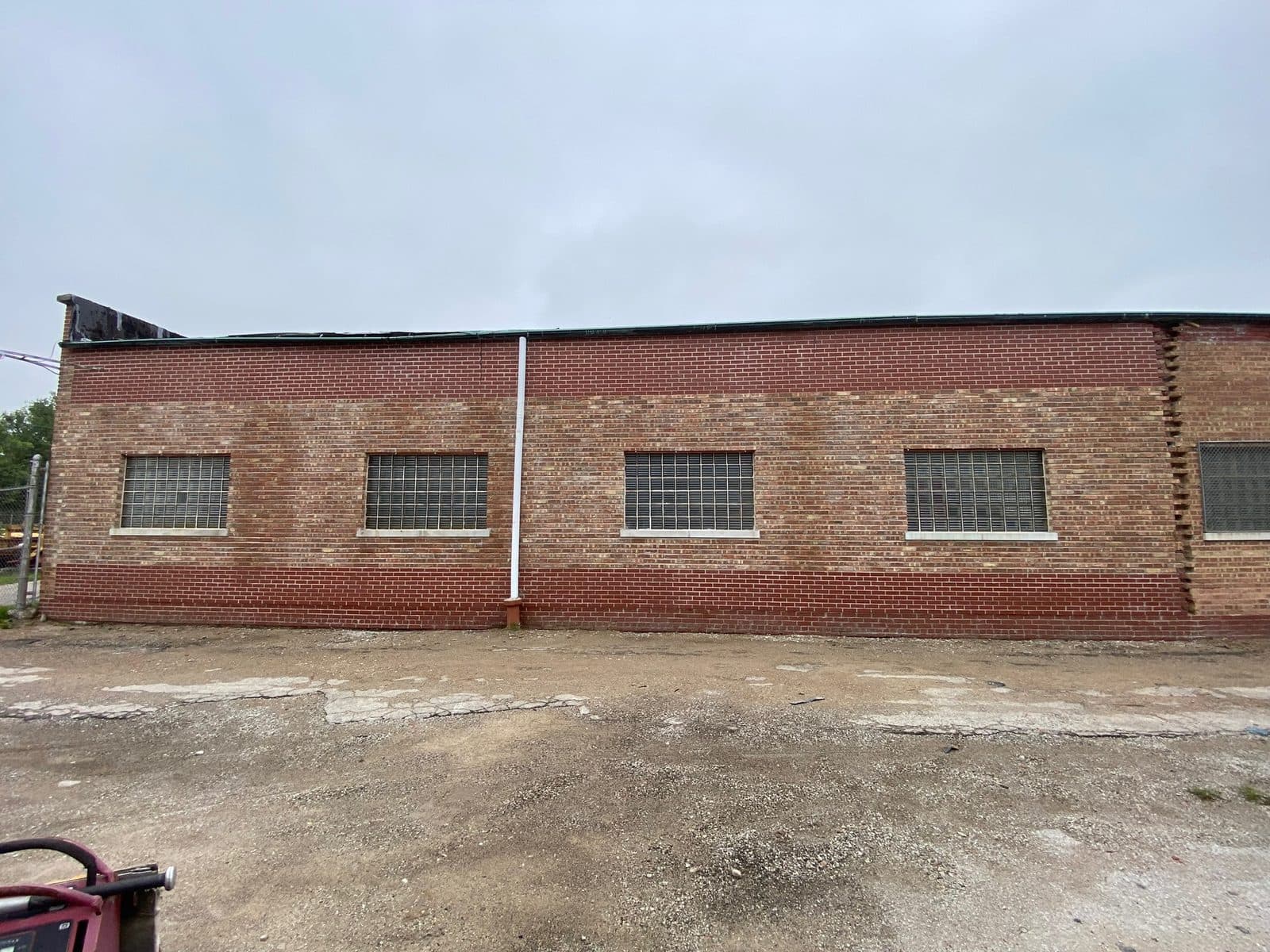 Restored brick facade and parapet on a commercial building in Naperville, IL by Paul Lally's Masonry