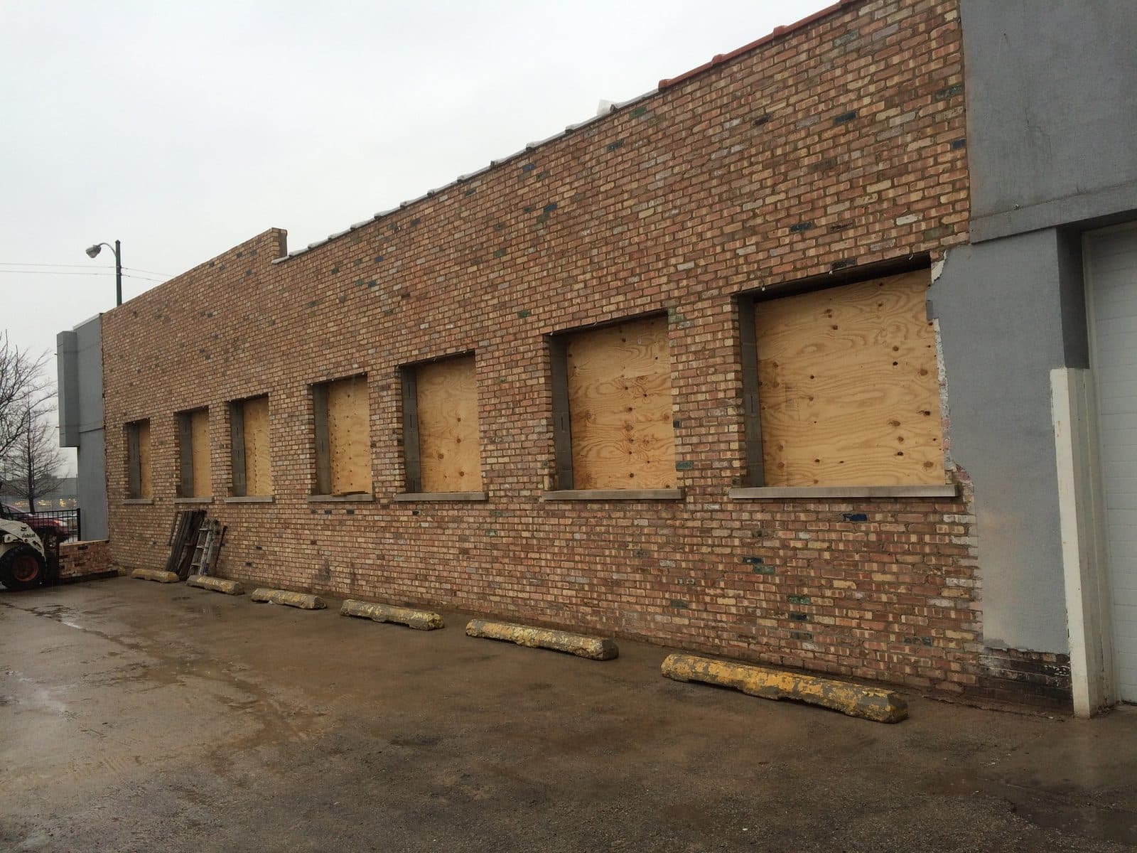 Restored limestone commercial storefront facade with repointed joints in downtown Lemont, IL
