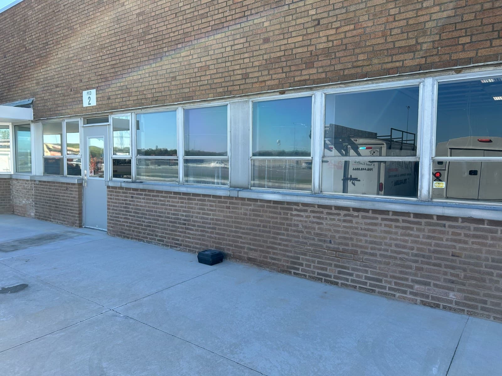 New steel lintel installed above a window with rebuilt brick coursing on a Chicago, IL building by Paul Lally's Masonry