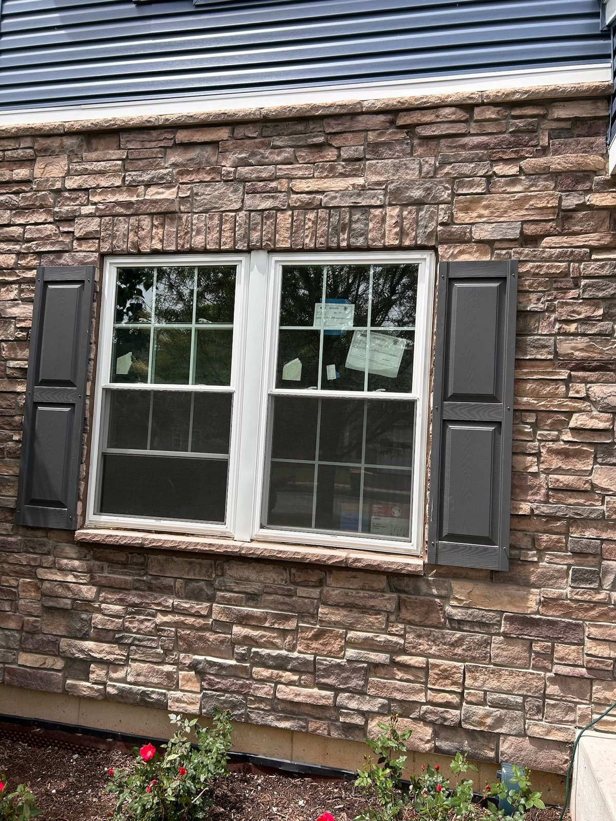 Restored limestone window sill and stone trim on a Downers Grove, IL home by Paul Lally's Masonry